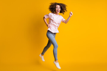 Fototapeta na wymiar Photo portrait full body view of girl jumping up running isolated on vivid yellow colored background