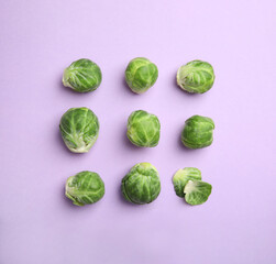 Fresh Brussels sprouts on violet background, flat lay