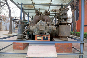 Fototapeta na wymiar The rusty turbine generator lay idle in a corner of the factory