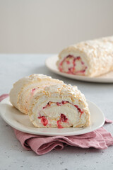 Meringue roll cake with cream, raspberries. Roulade, summer dessert. Confectionery, menu. Close up
