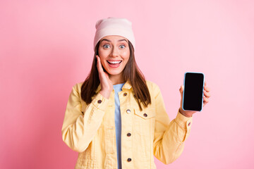 Portrait of attractive astonished person arm on cheek open mouth headwear cap isolated on pink color background