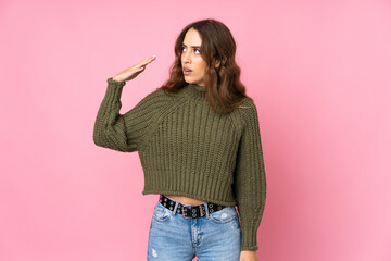 Young woman over isolated pink background with tired and sick expression