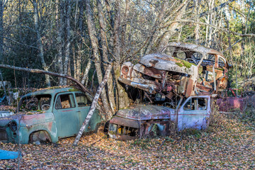 Car wrecks in the forest of Varmland during fall in Sweden