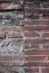 Old brick destroying wall. Fragment of the wall of baked brown brick in. Close-up. Texture. Background.