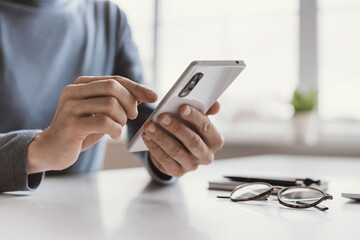 Young business man using phone at office, Communication, connection, business, people, technology concept, Closeup photo of male hands with smartphone