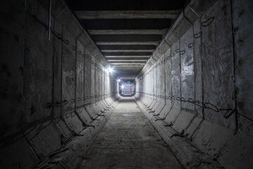 Large empty square reinforced concrete tunnel. Construction of a shallow subway tunnel ventilation.
