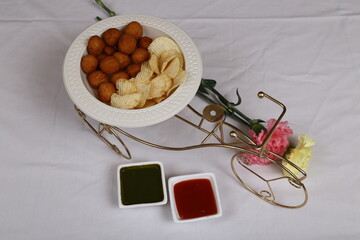 Fried potato cheese balls or croquettes with potato chips served with green chutney and tomato ketchup