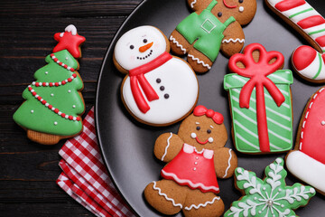 Delicious Christmas cookies on black wooden table table, flat lay
