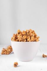 Caramel popcorn in a white bowl