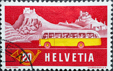 Switzerland - Circa 1953 : a postage stamp printed in the swiss showing a yellow post bus from the...