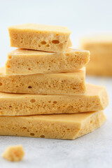 Dessert caramel honeycomb toffee on a white background.