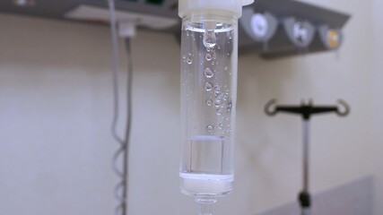Fluid Drug Dripping from Intravenous Therapy Drip-Bag in Hospital Room