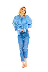 Fototapeta premium Portrait of blonde woman in blue jeans and shirt isolated on white background