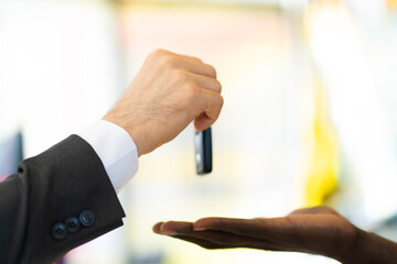 Middle age business man with beard gives the car key to customer service at Car maintenance station and automobile service garage