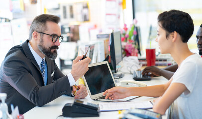 Middle age business man with beard gives the car key to customer service at Car maintenance station and automobile service garage