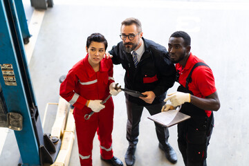 Professional car mechanic Teamwork in workshop concept.  Diversity group of mechanics people in car service station.