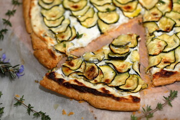 Zucchini tart on wooden table. Shortcrust pastry. Cream, egg, cheese fill. Shortcrust tart with cheese and zucchini.