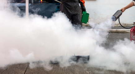 Fototapeta premium Man teaches or training how to use carbon dioxide (CO2) fire extinguishers to extinguish fires from fuel.