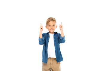 Positive boy looking at camera while pointing up with fingers isolated on white