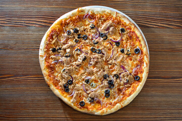 Delicious pizza with olives and sausages on wooden table, top view