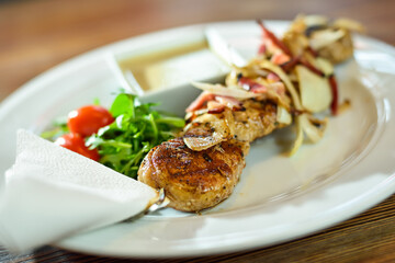 Grilled beef shishkabobs on table close up