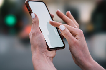 Crop woman scrolling news on phone