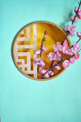 Circle traditional window frame with cherry blossom on green background         