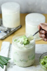 Obraz na płótnie Canvas Buko salad or buko pandan, usually sliced ​​as a young coconut salad,is a Filipino fruit salad dessert made from chunks of fresh young coconut with sweetened milk or cream and various other ingredient