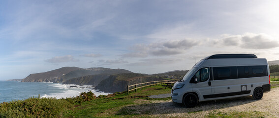 camper van parked high up on cliffs of a wild and rugged coastline