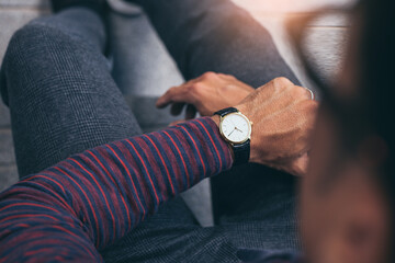 fashionable wearing stylish looking at luxury watch on hand check the time at workplace.concept for managing time organization working,punctuality,appointment