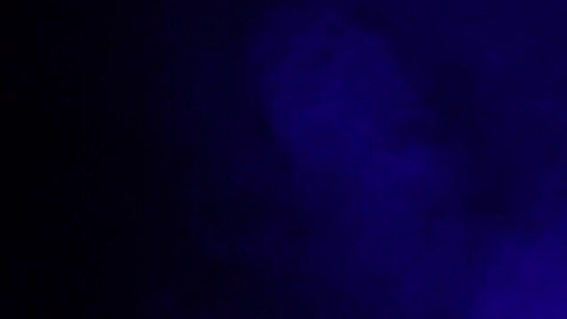 Blue smoke from a smoke machine in slow motion
