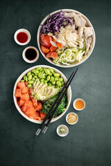 Top view of poke bowls composition with various sauces