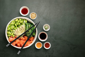 Top view of poke bowls composition with various sauces