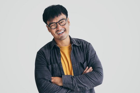 asian man portrait young male wear eye glasses smiling cheerful look thinking position with perfect clean skin posing on white background.fashion people life style concept