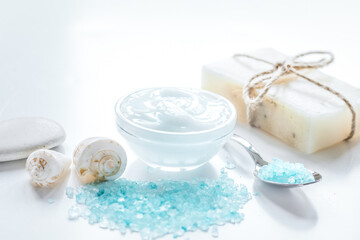 Fototapeta na wymiar spa composition with blue sea salt and natural soap on white desk background