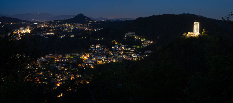 Como - The castle Cestello Baradello and  the city among the mountains at dusk.