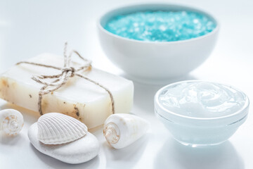 Fototapeta na wymiar sea salt, soap and body cream on white desk background