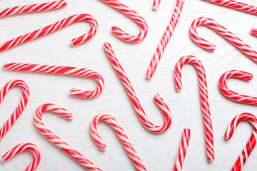 Sweet Christmas candy canes on white wooden