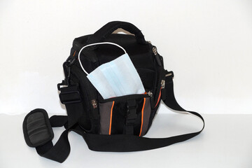 medical mask in camera bag close up