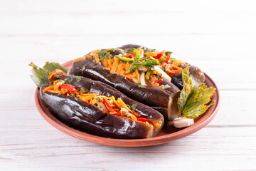 Pickled eggplants with vegetables and carrots in a plate. Delicious and healthy dishes.