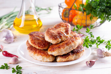 Delicious fish cutlets in a plate on the table. Horizontal