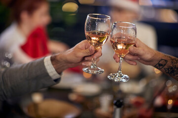 A group of colleagues drinking and eating  at New Year's company dinner at a restaurant. Together, New Year, celebration