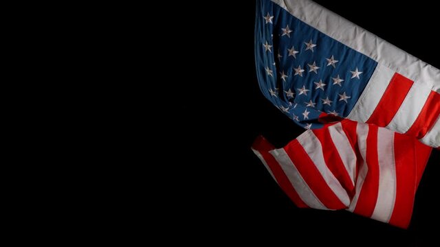 Super slow motion of waving flag of USA isolated on black background. Filmed on high speed cinema camera, 1000fps.