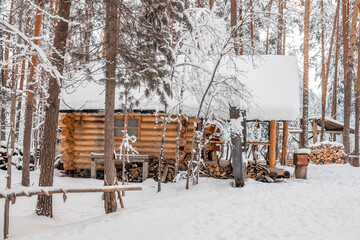 Wooden house in the winter forest.