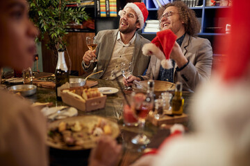 Group of colleagues enjoying New Year company dinner at a restaurant. Together, New Year, celebration