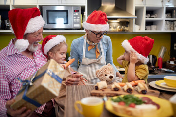 Grandparent like to be with grandchildren in the kitchen for a Xmas. Christmas, family, together