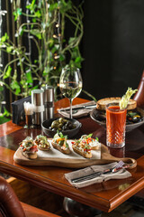 Brushetta bread sandwich snack authentic traditional spanish tapas on wooden plate at the restaurant