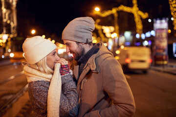 A young couple in love having moments of closeness in a walk of the city. Relationship, together, Xmas