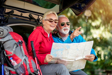 Senior hikers looking at map