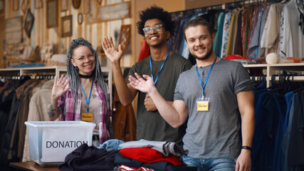 Portrait of young diverse volunteer group with clothes for donation - Powered by Adobe